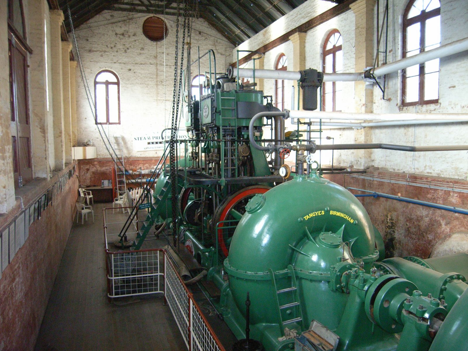 Psyche Bend station pump, the pump is large and green in colour and is held within a room.
