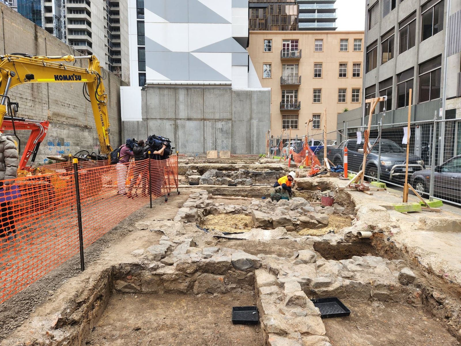 Images shows an archaeologist excavating Buried Block in Melbourne