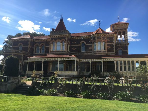 Rippon Lea house, image shows the exterior of the house. The house is made of red brick and looks glamorous.