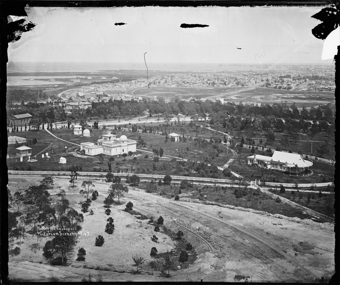 Panorama of Melbourne taken from Government House tower, showing the Melbourne Observatory complex . The image is in black and white