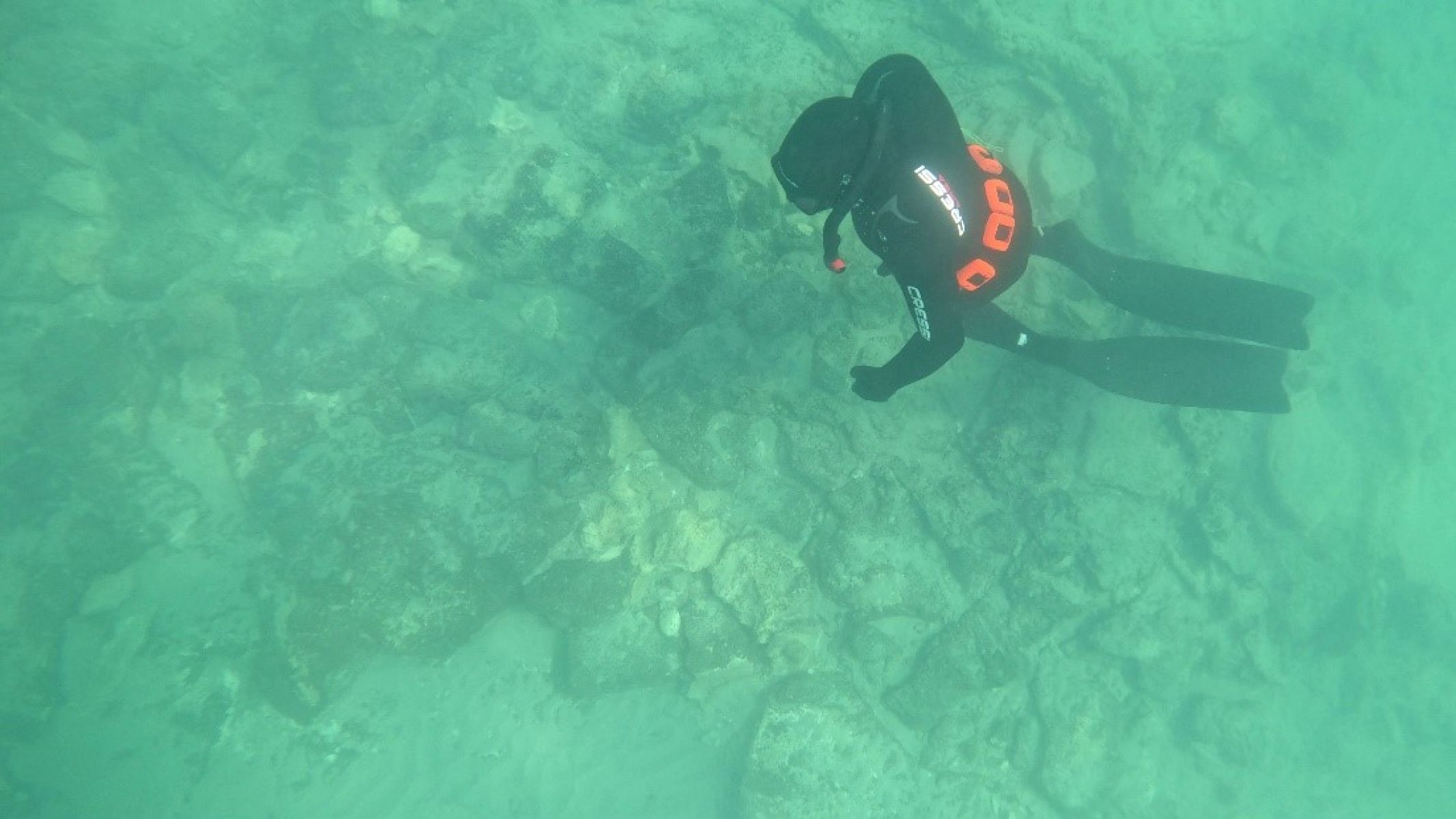 Image shows a diver underwater viewing the wreck.