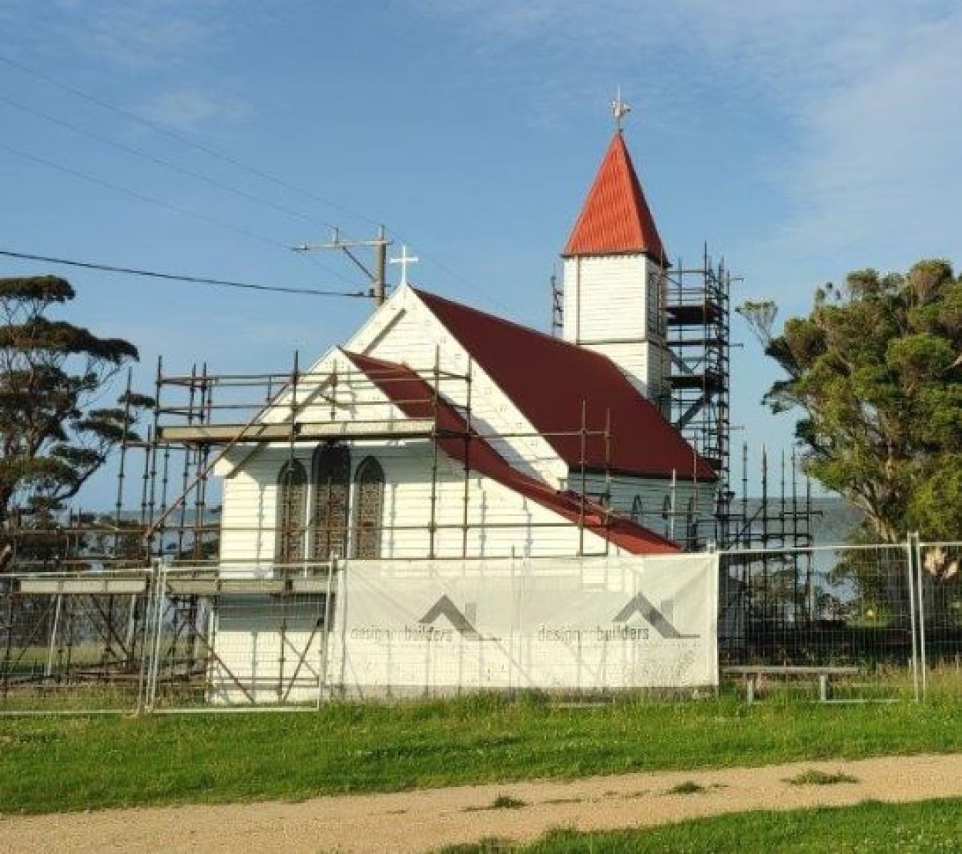 Image shows the Church during its renovations. Scaffolding can be seen around the church and it is a sunny day. 